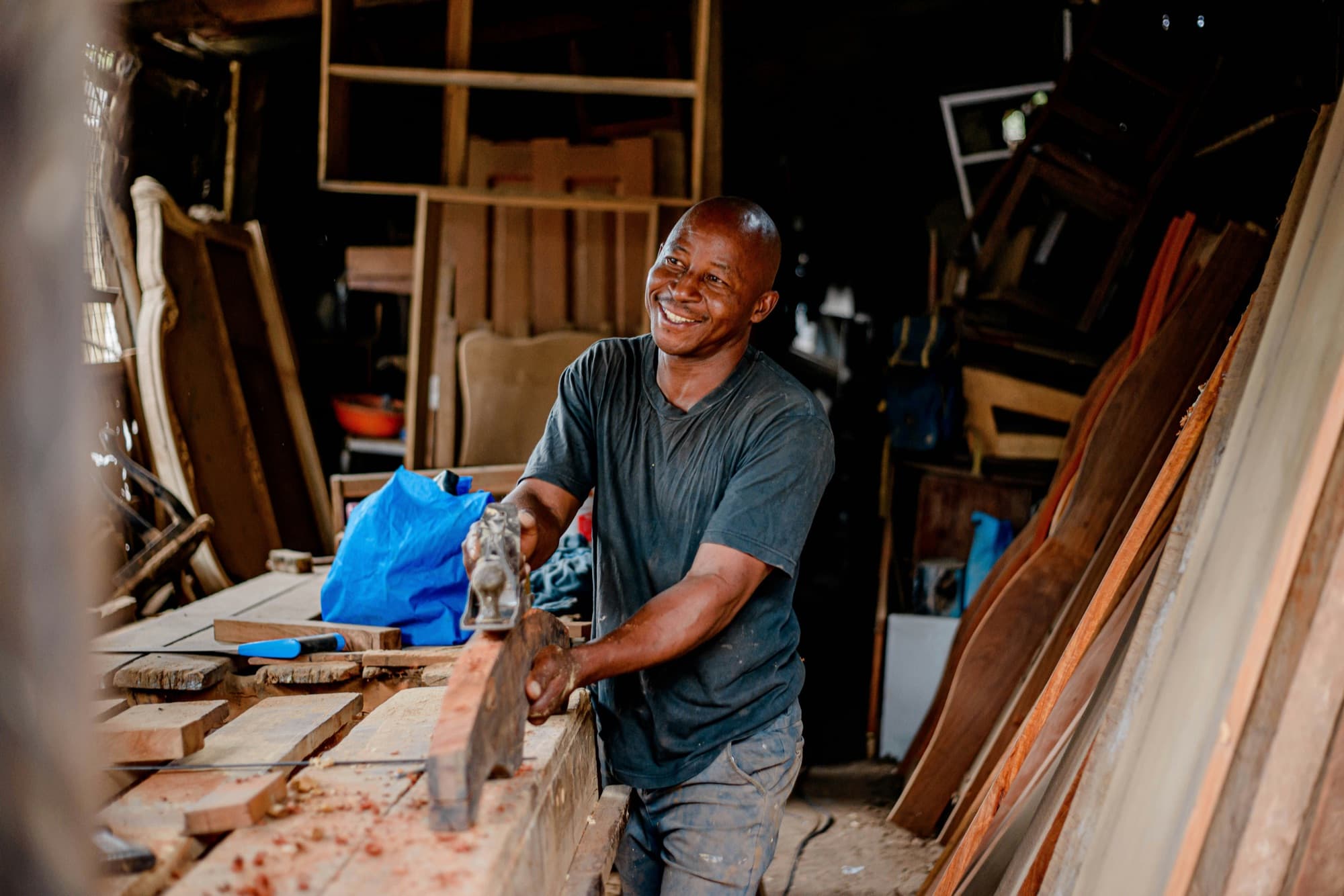 A South African carpenter smiling in his workshop